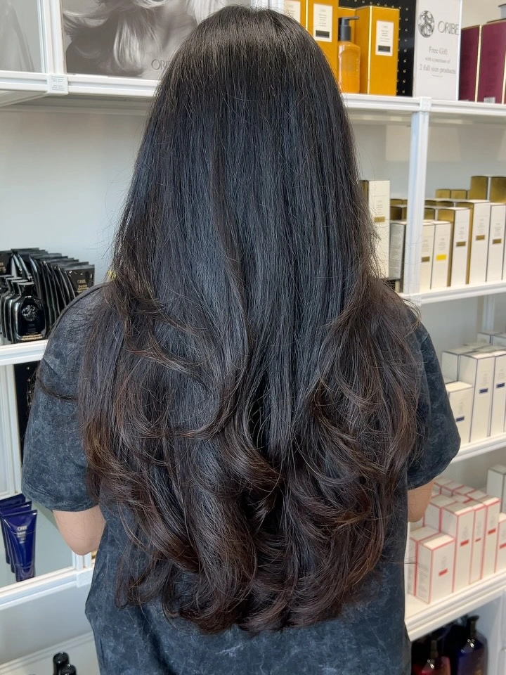 Very long dark hair with layered curled ends