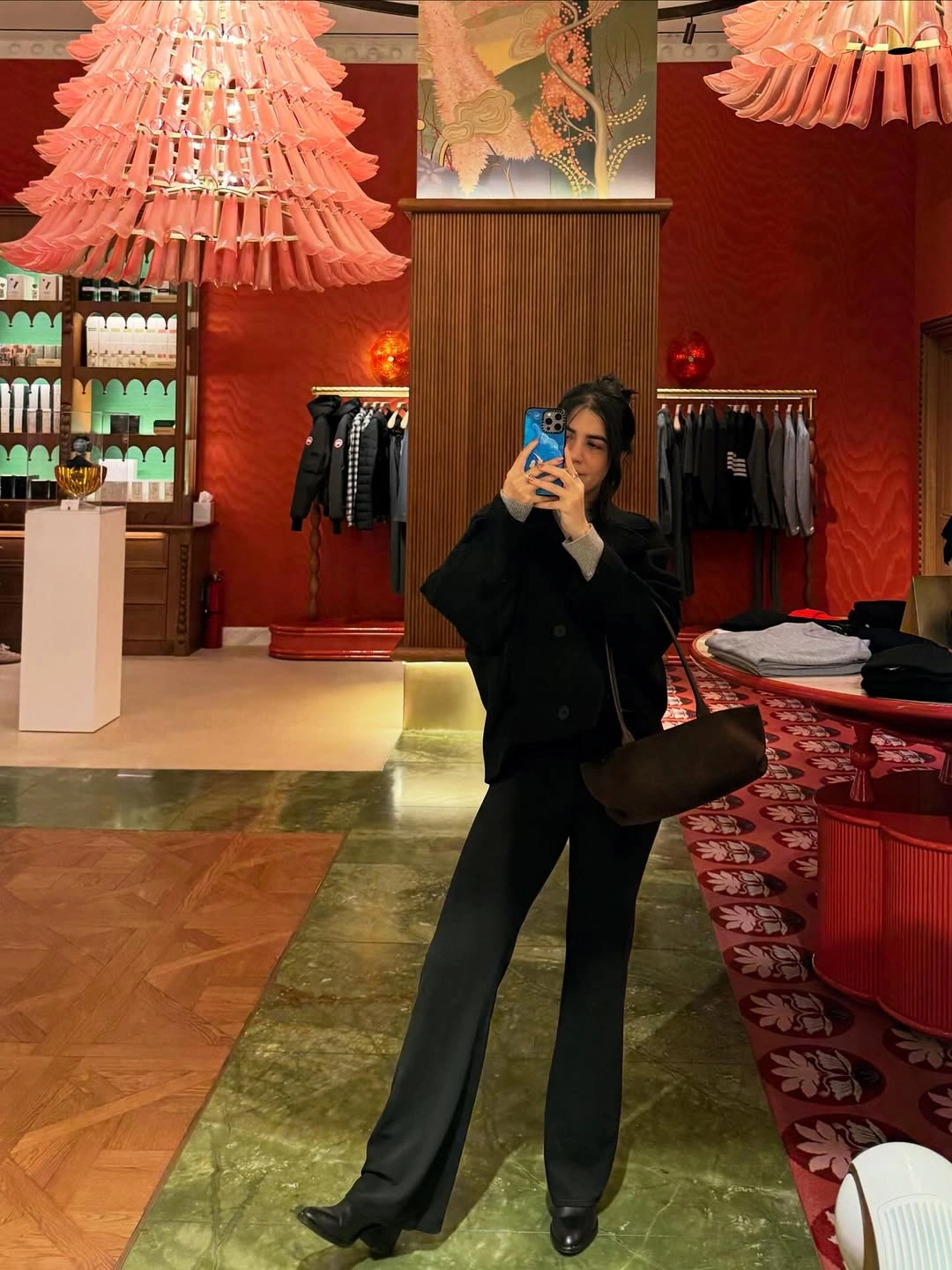 Mirror view in short black jacket, wide trousers, and dark shoes