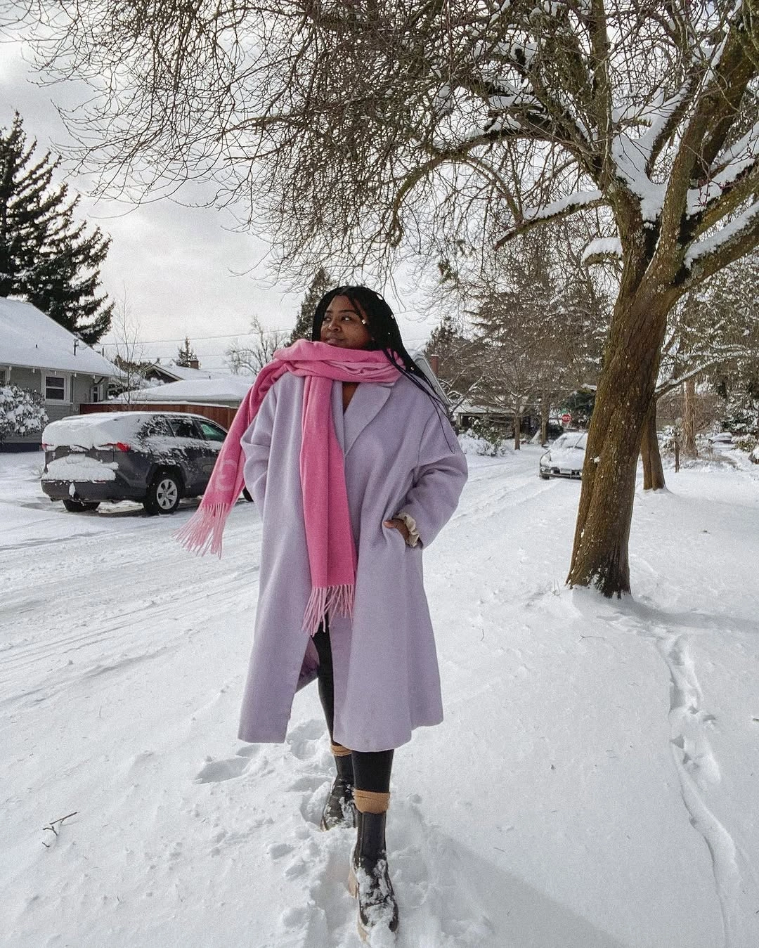 Pale lavender coat and pink scarf on snowy street