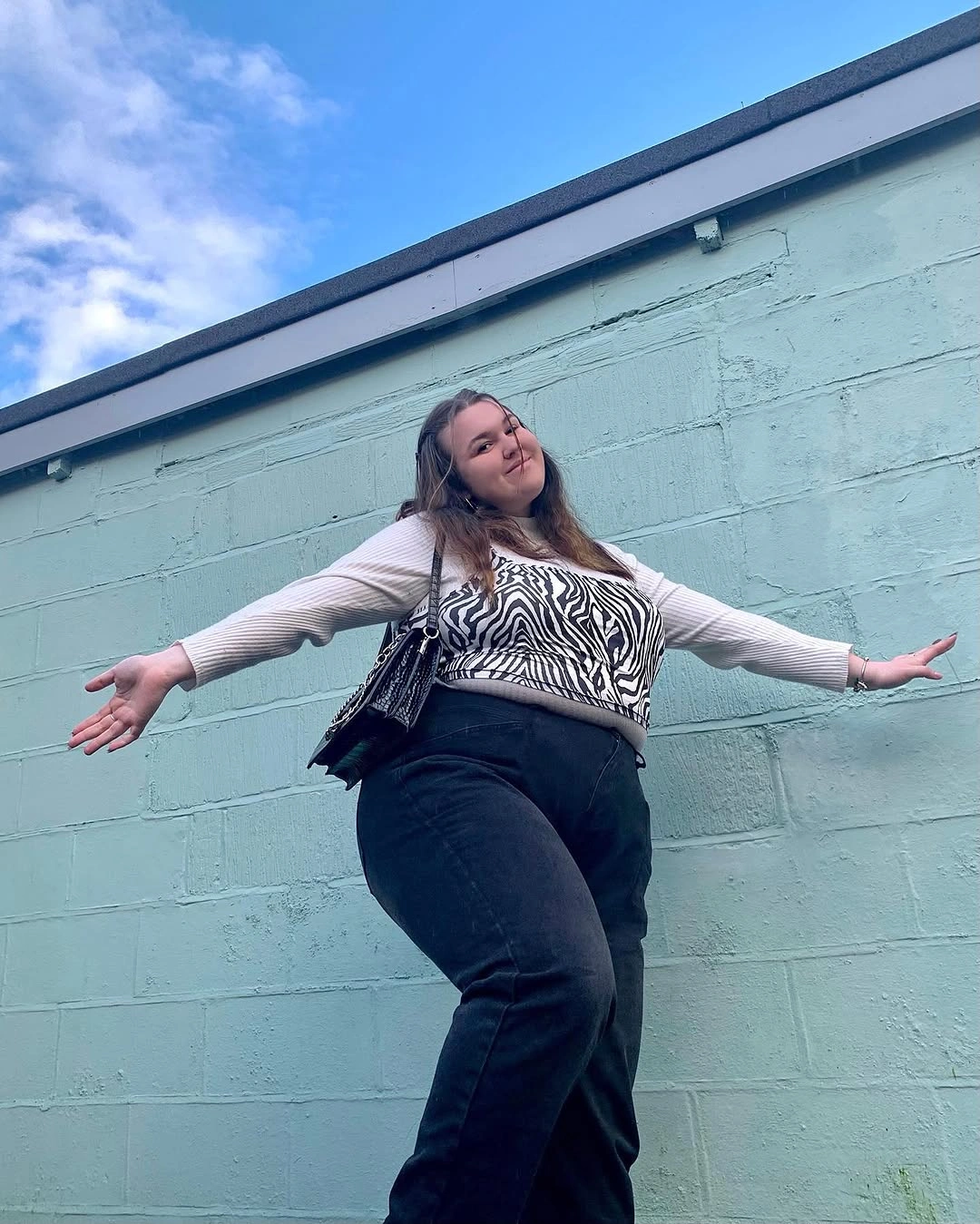 Zebra print top with pale cardigan and black bottoms