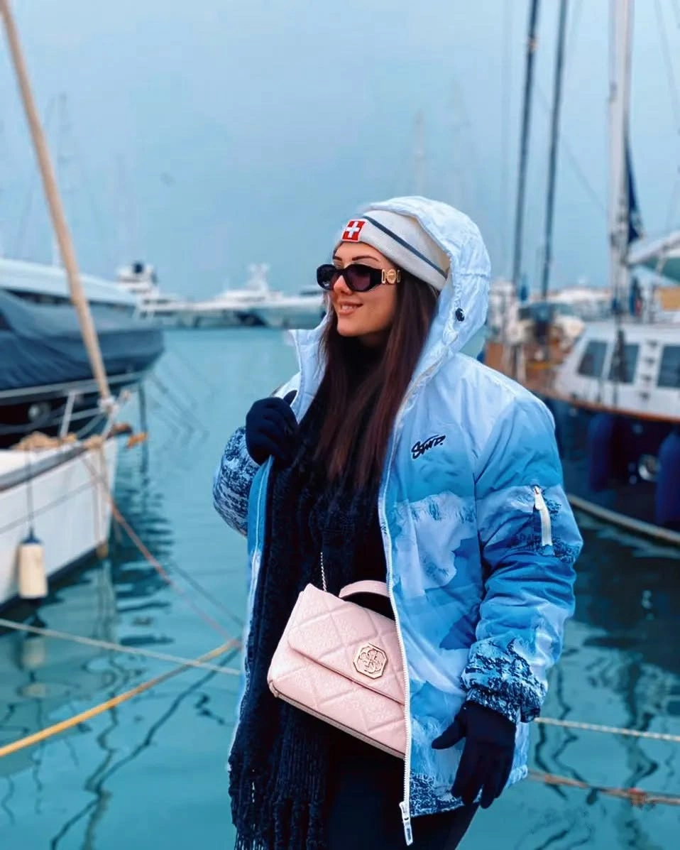 Blue-and-white hooded puffer with pink quilted bag