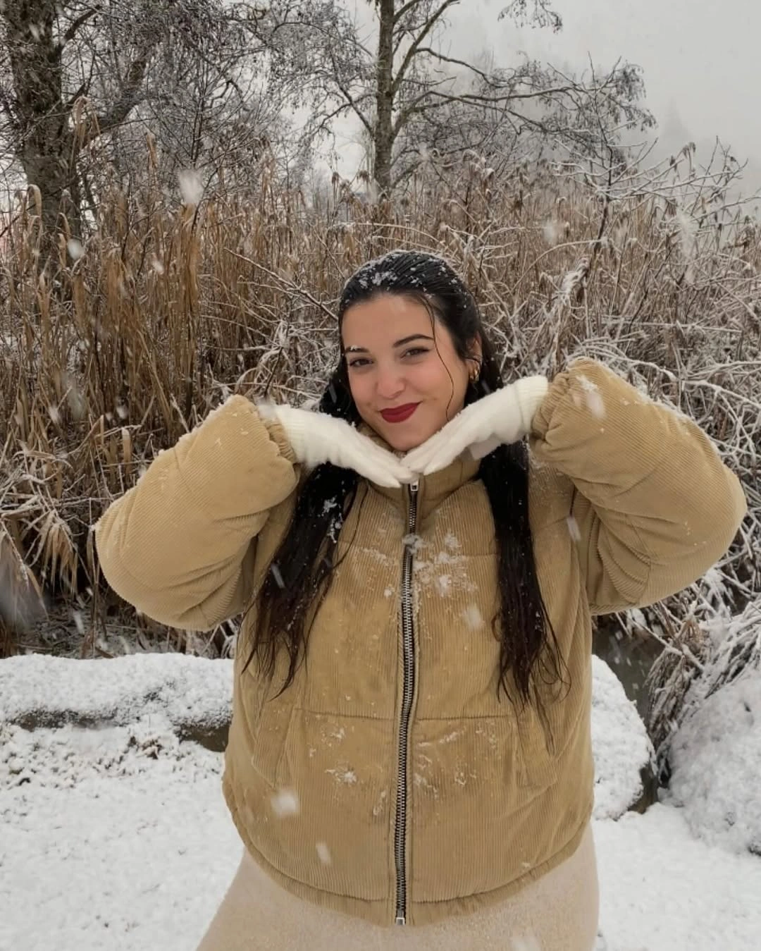 Tan zip jacket with plush cream collar in snow