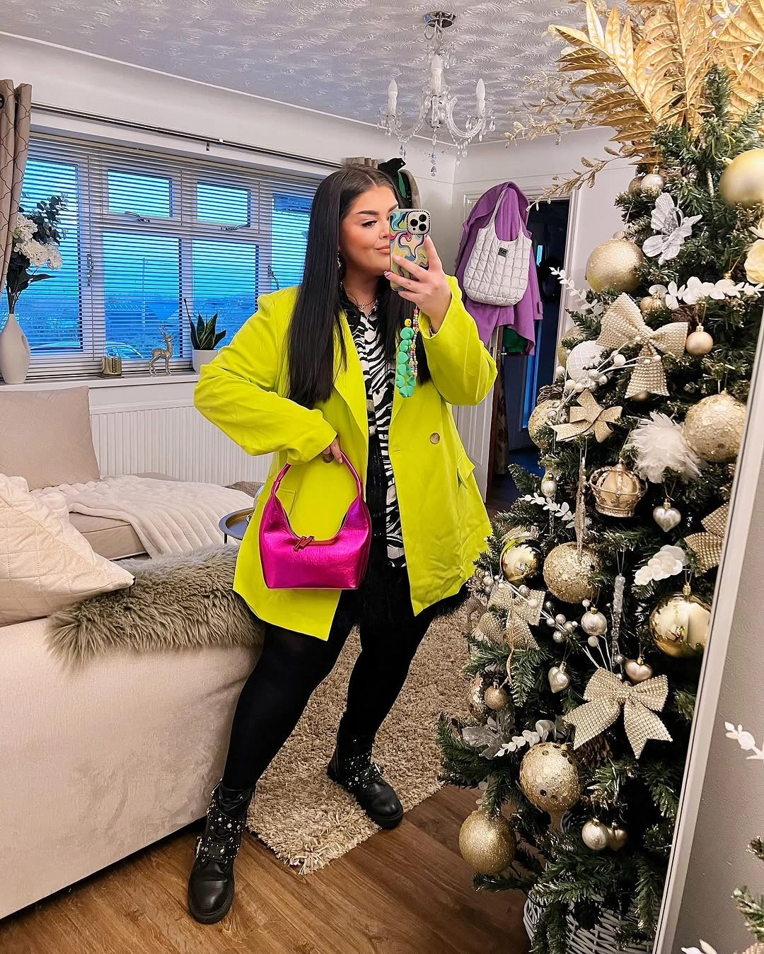 Bright yellow green coat, patterned layer, pink bag and black boots