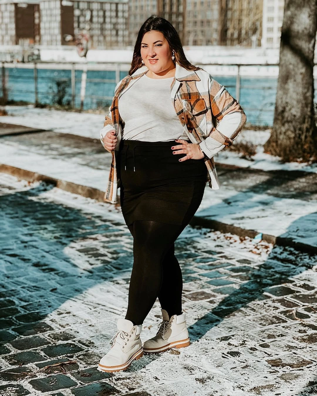 Plaid overshirt with white top, dark tights and white boots