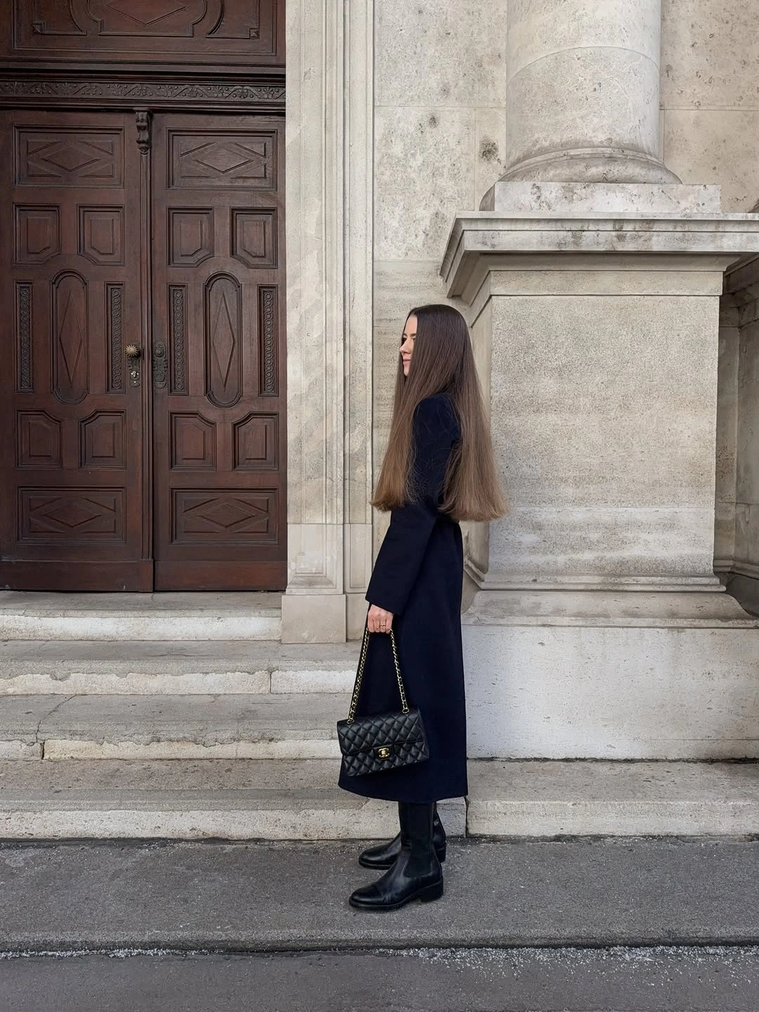 Long dark coat or dress-like layer with black boots