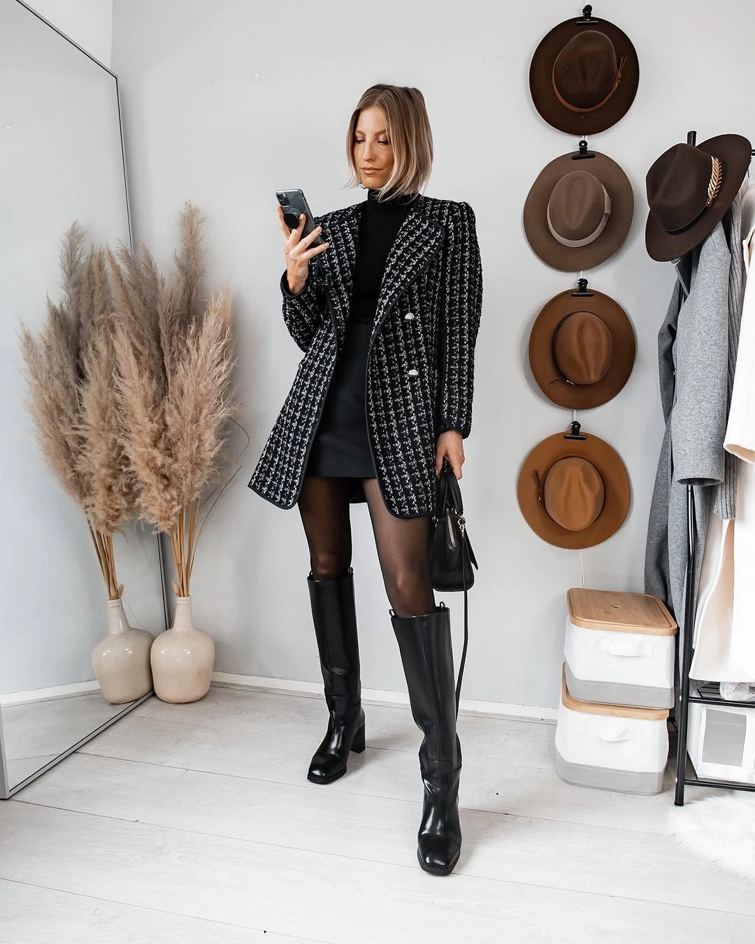 Black patterned coat with sheer tights and tall boots