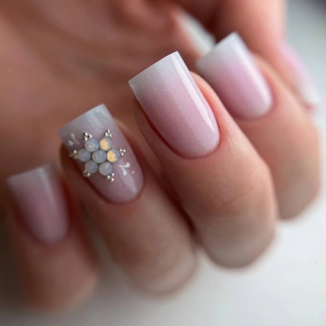 Long soft pink squared nails with pearl-like winter accent