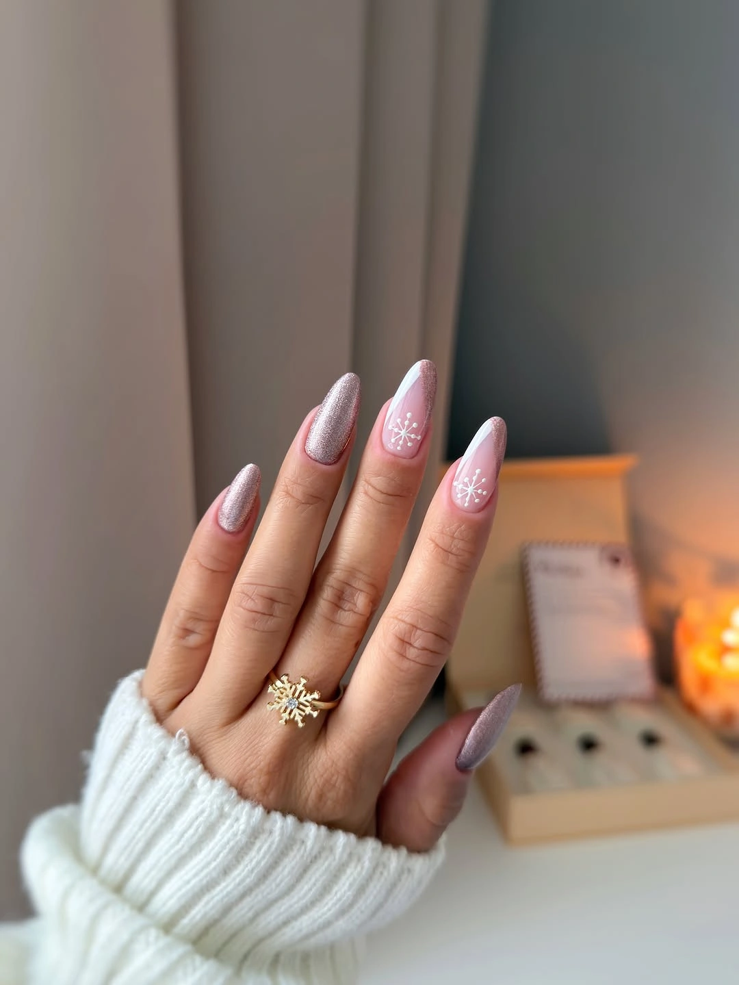 Long pointed pink and silver shimmer nails with snowflake accents