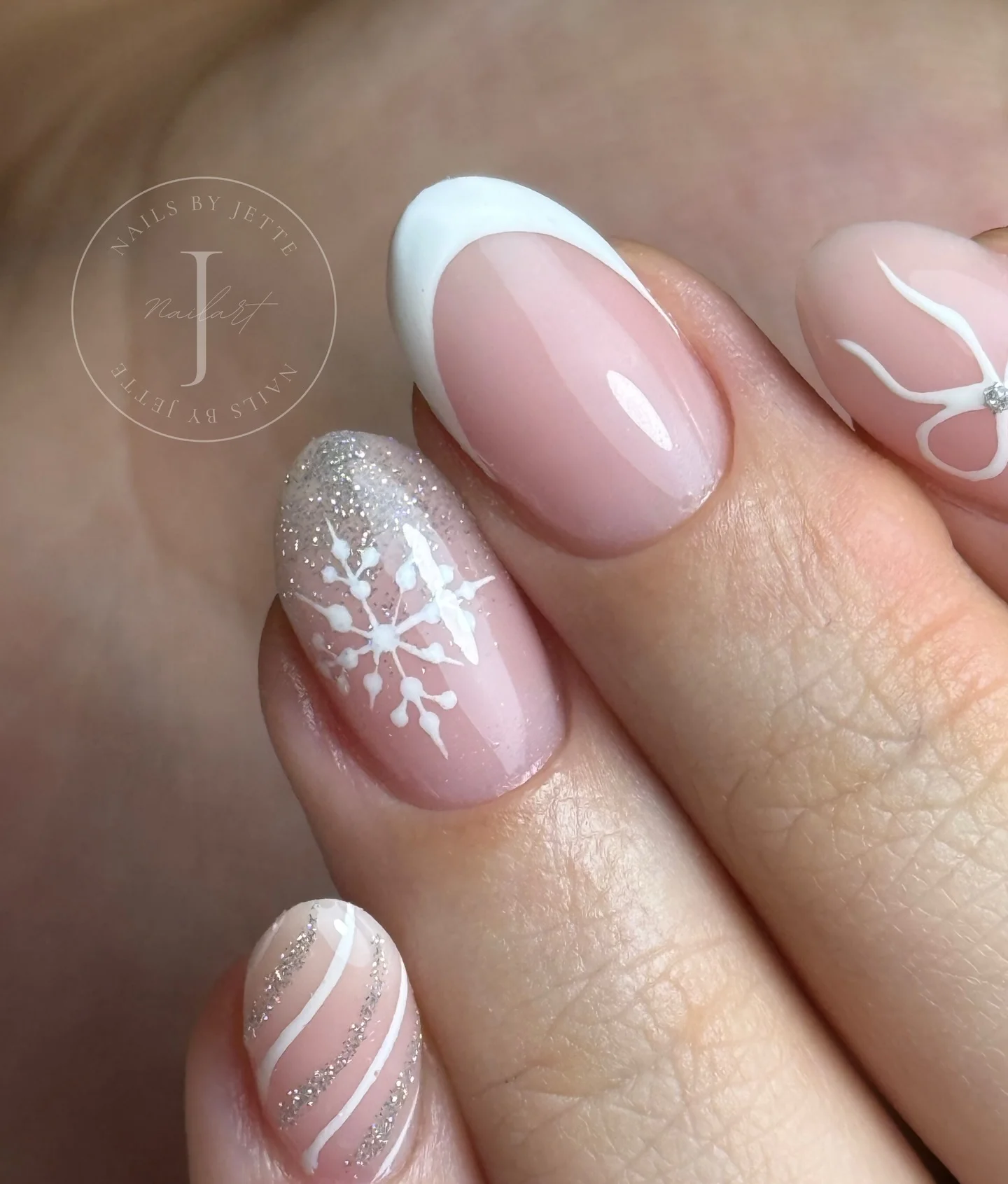 Pale pink nails with white tip, snowflake and silver stripes