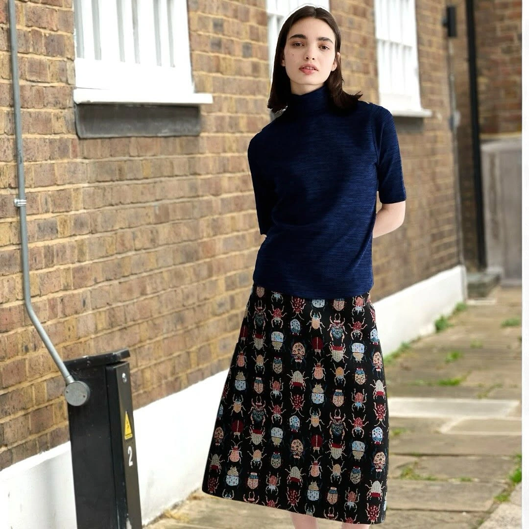 Navy high-neck top with black patterned A-line skirt