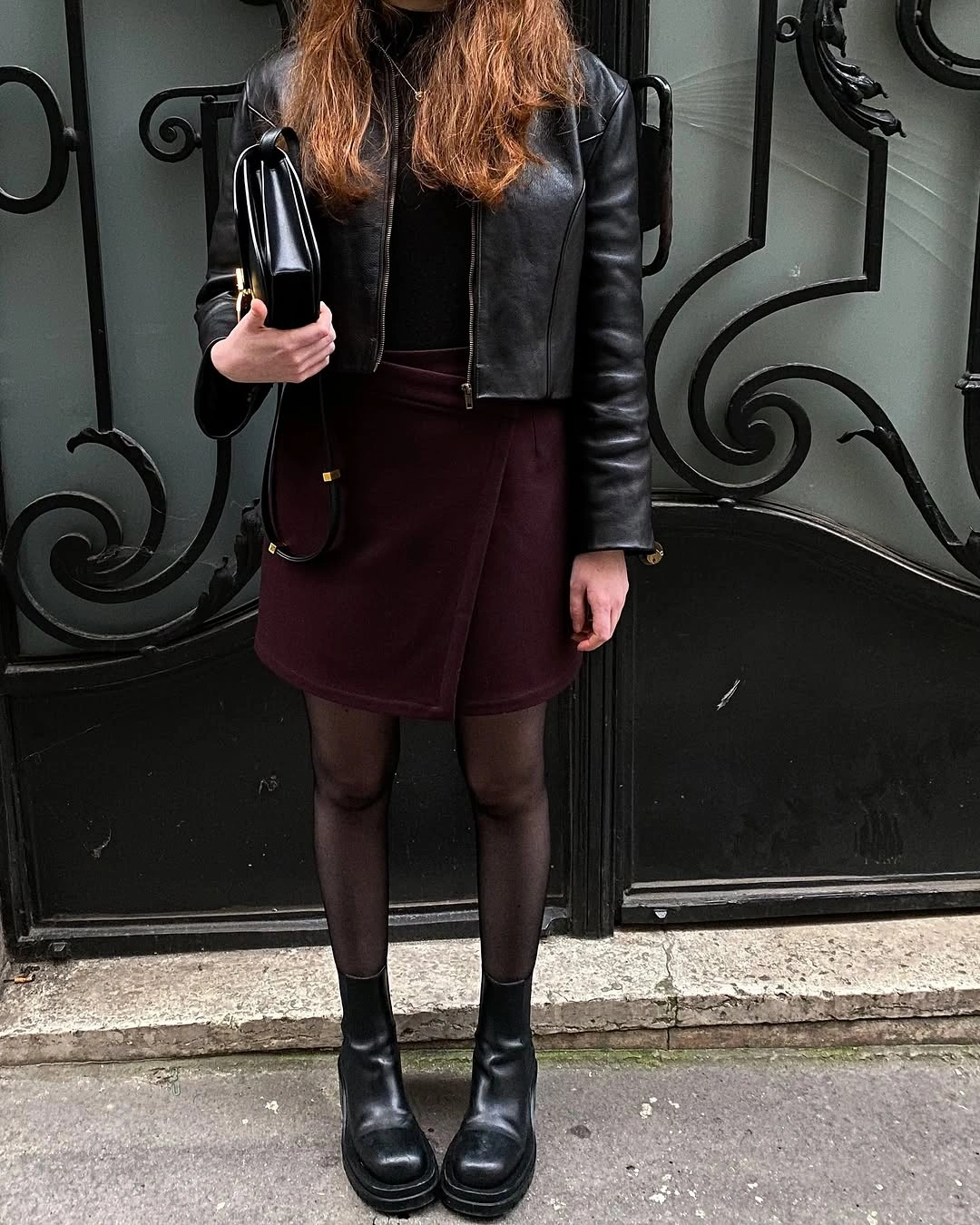 Leather-looking cropped jacket with burgundy short skirt and black boots