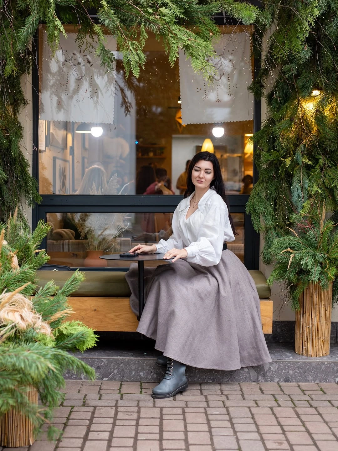 White blouse with pale full midi skirt and gray lace-up boots