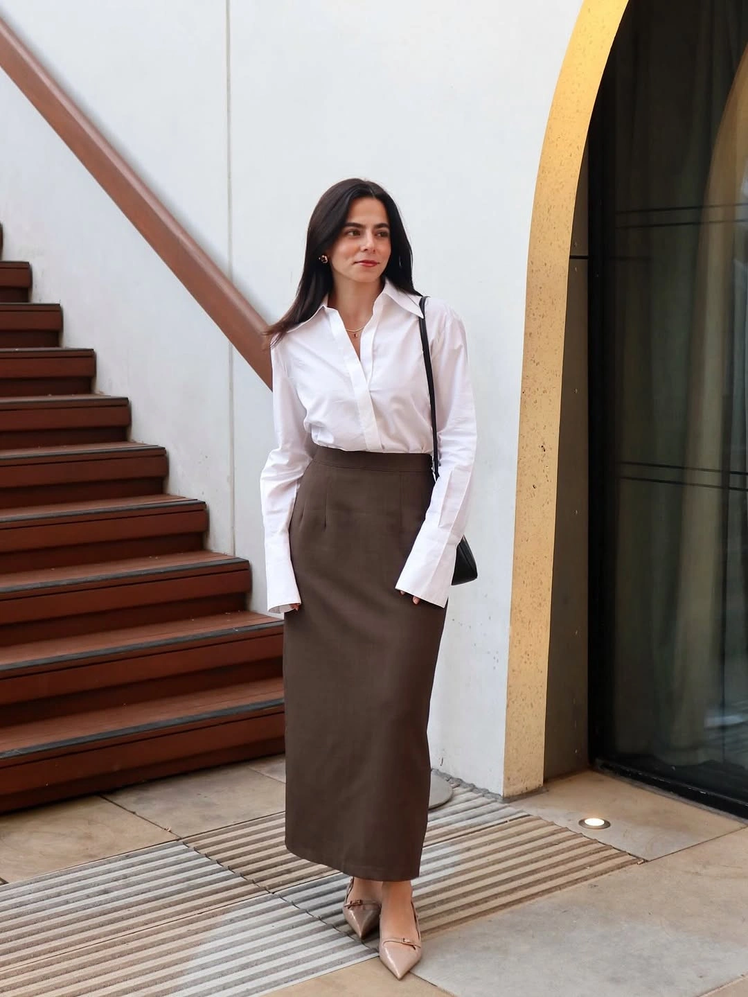White button-down shirt with straight brown midi skirt and pointed shoes