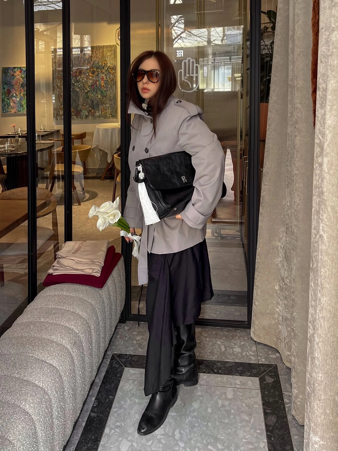 Gray double breasted jacket with dark layered bottoms and black boots