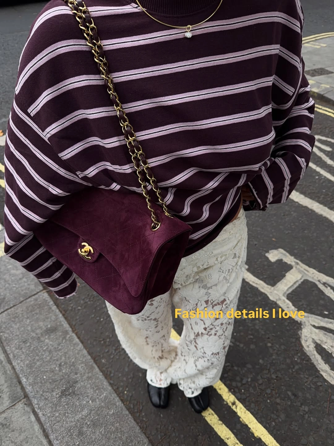 Plum striped sweater with cream floral trousers and chain strap bag
