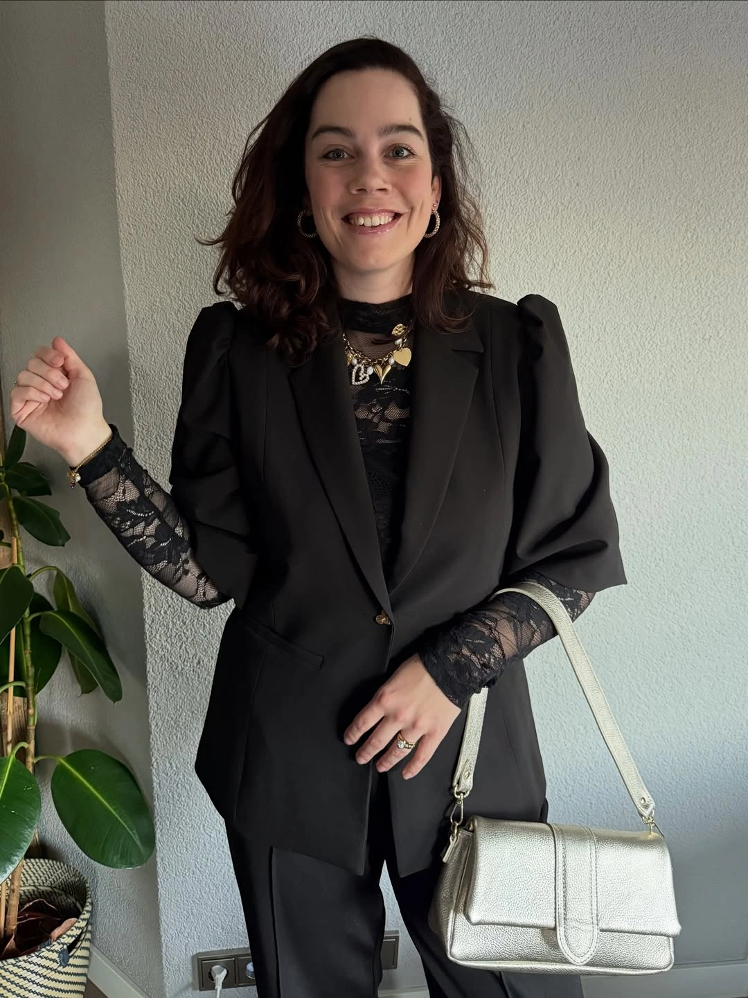 Black blazer with lace sleeves, trousers and pale shoulder bag