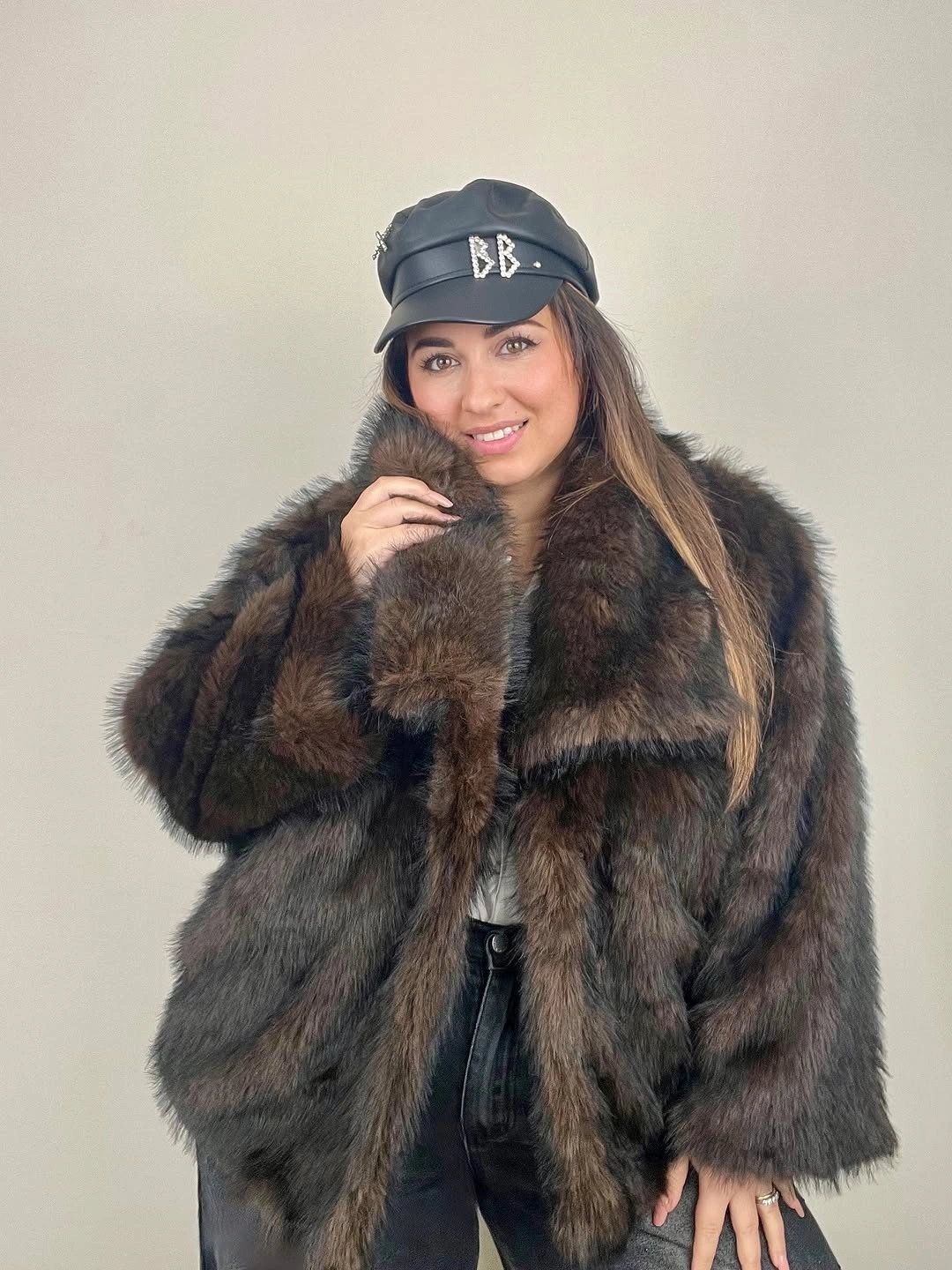 Shaggy brown coat with black cap and dark jeans