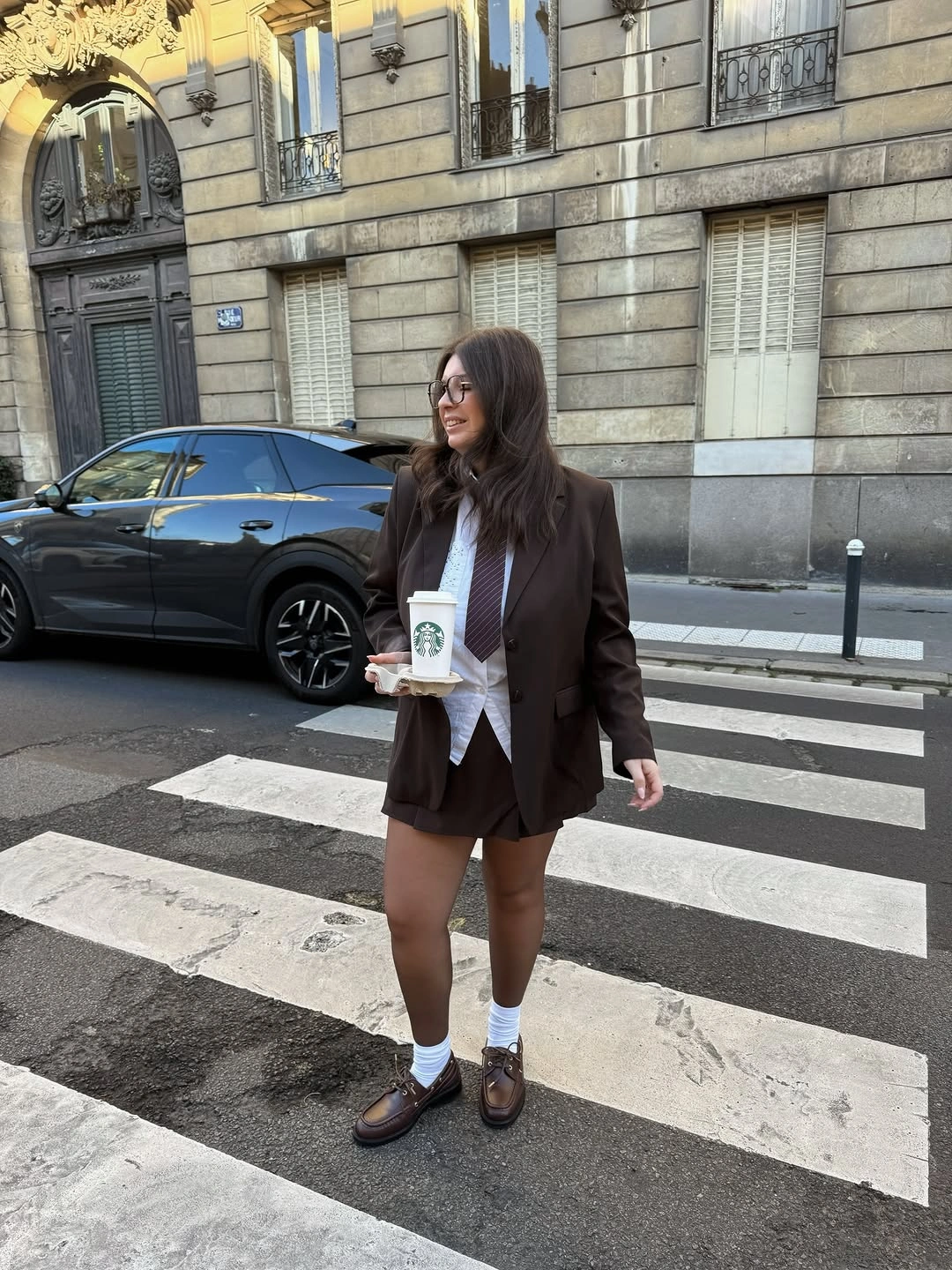 Dark blazer with white shirt, tie, socks and loafers