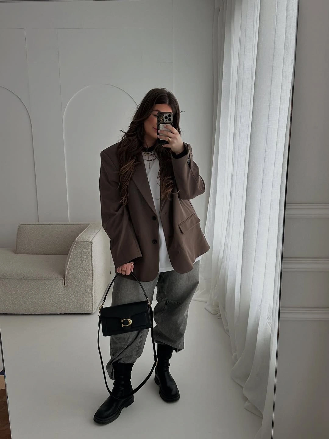 Brown blazer, gray trousers, black boots and structured bag