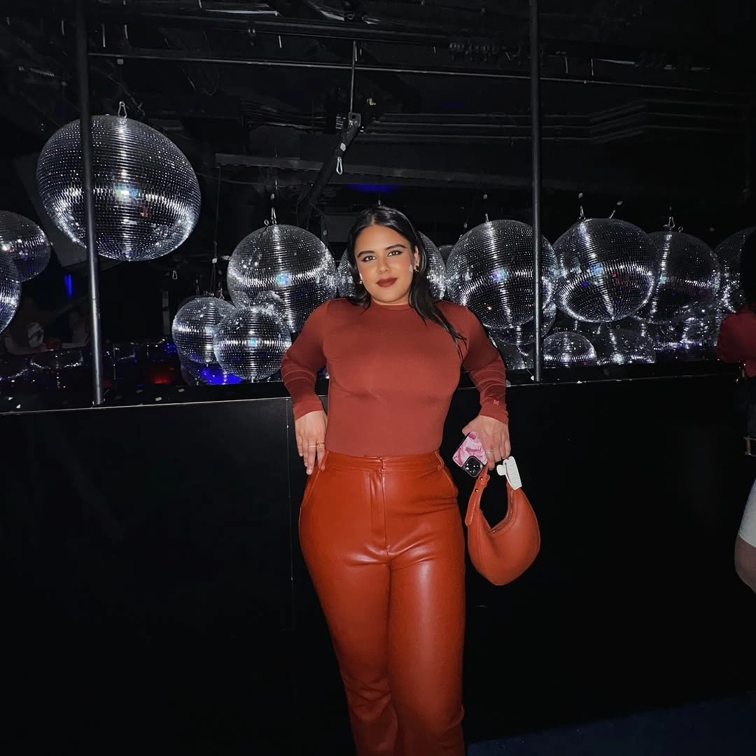 Rust fitted top with glossy rust trousers and matching bag