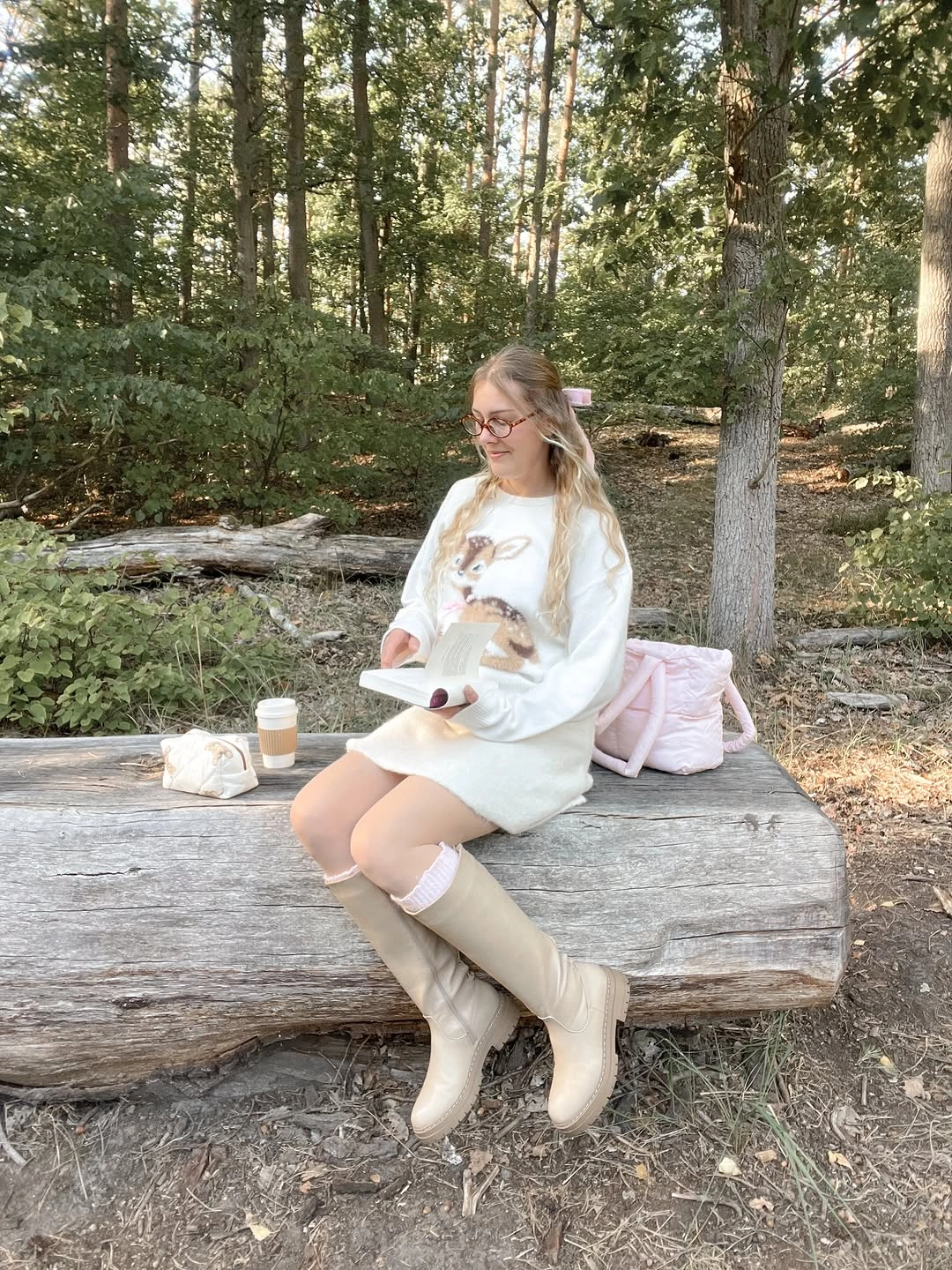 Long cream graphic top with pink socks, beige boots, and backpack