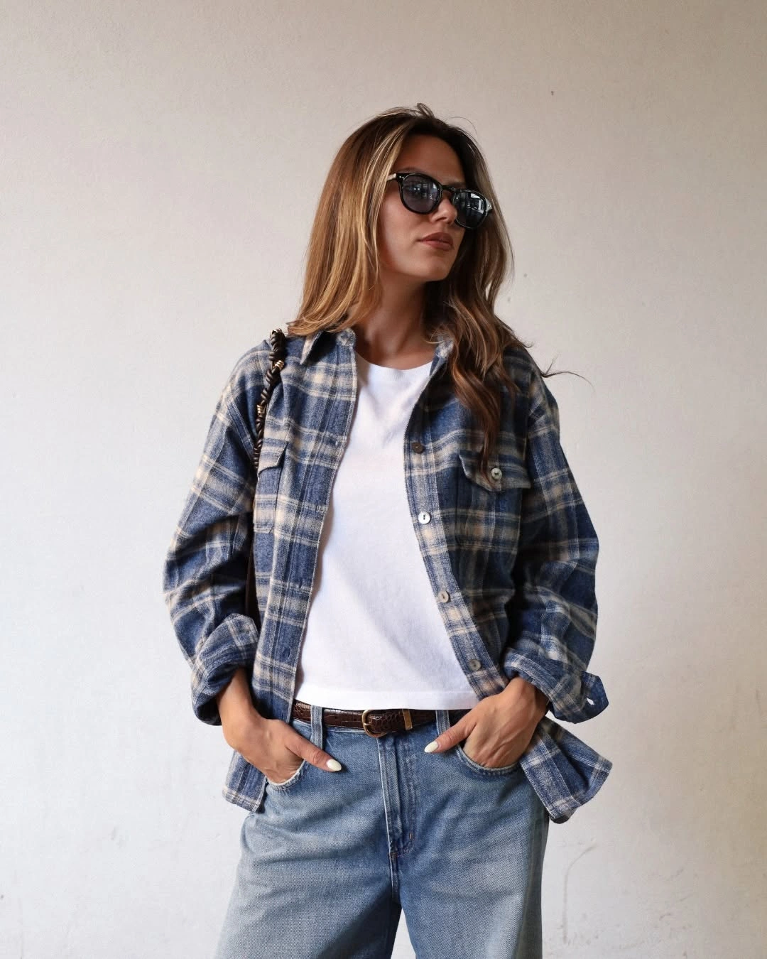 Blue-gray plaid overshirt with white tee and light-wash jeans