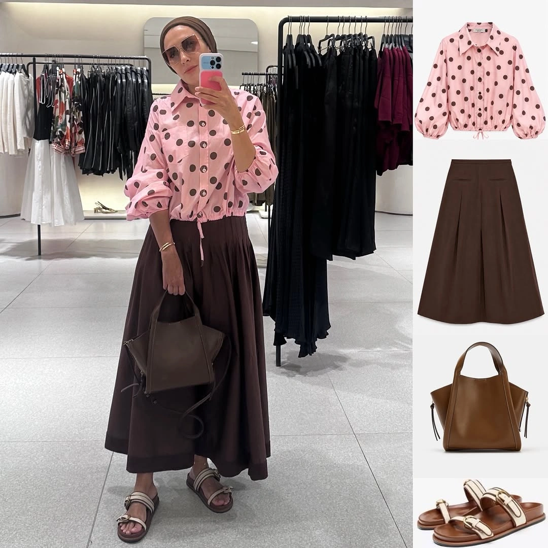 Pink polka-dot blouse with long brown skirt, tote, and sandals