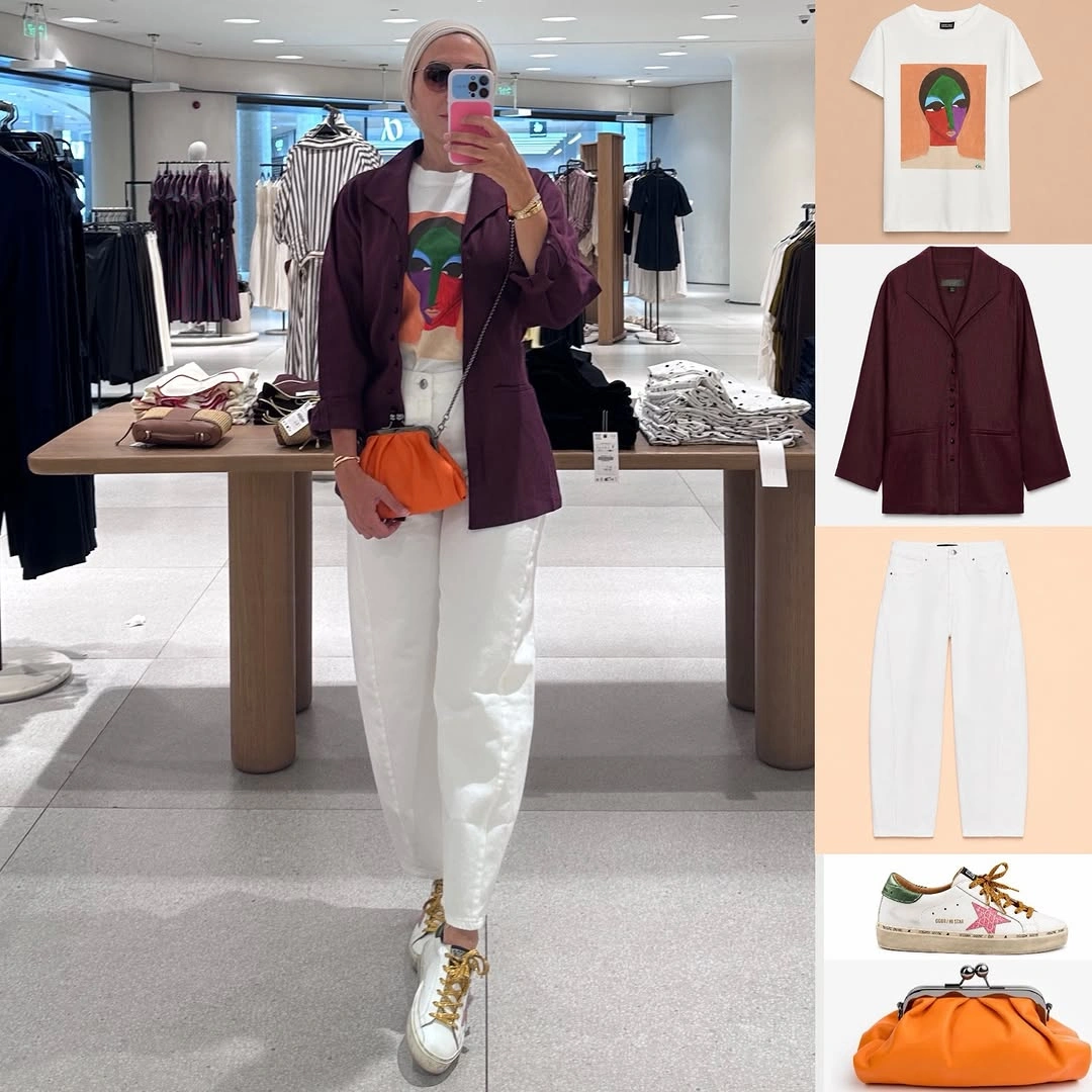 Burgundy blazer with graphic white tee, white trousers, and orange bag