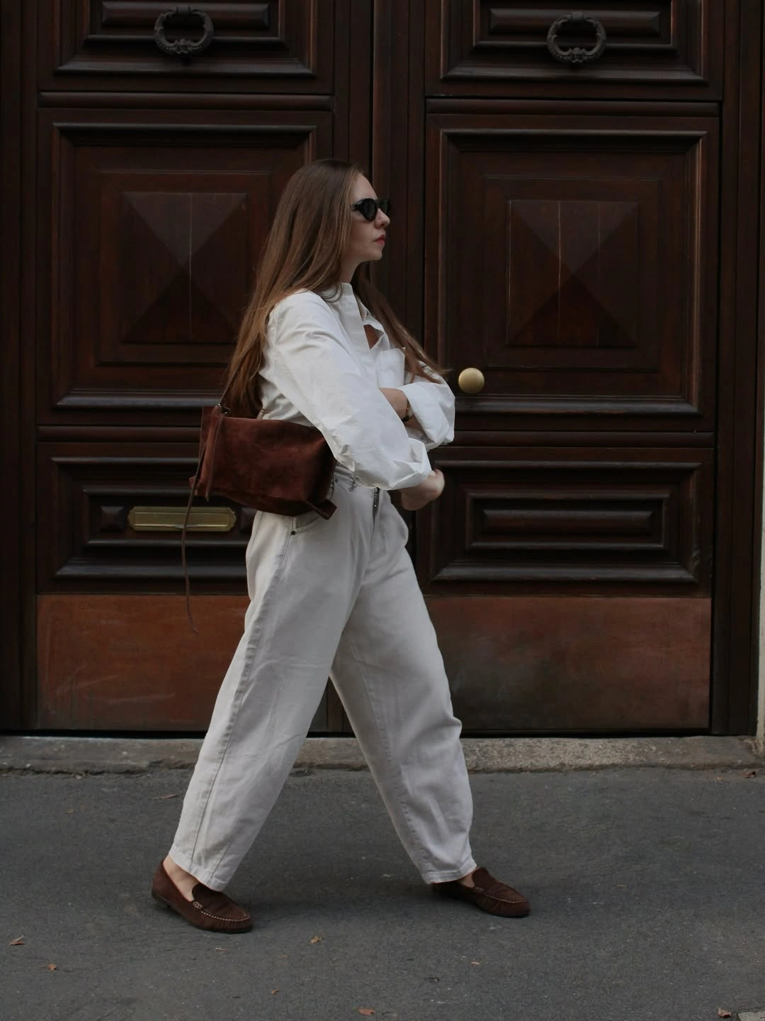 Cream shirt and loose pants with brown loafers and bag