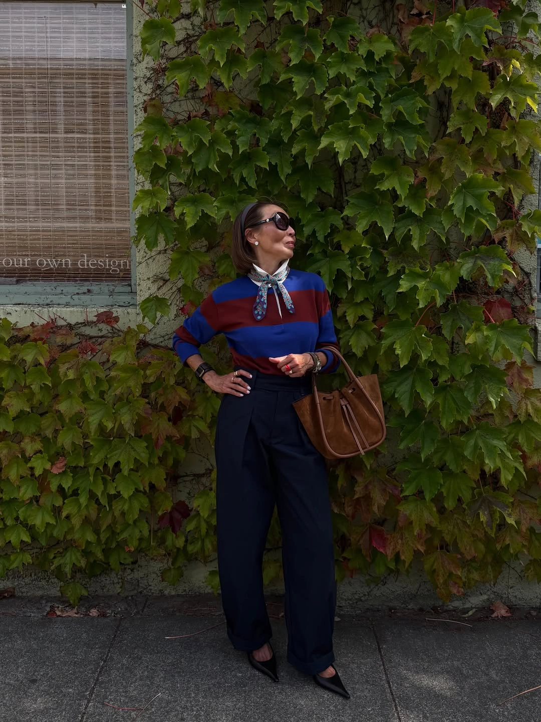 Striped top with navy wide trousers and brown tote