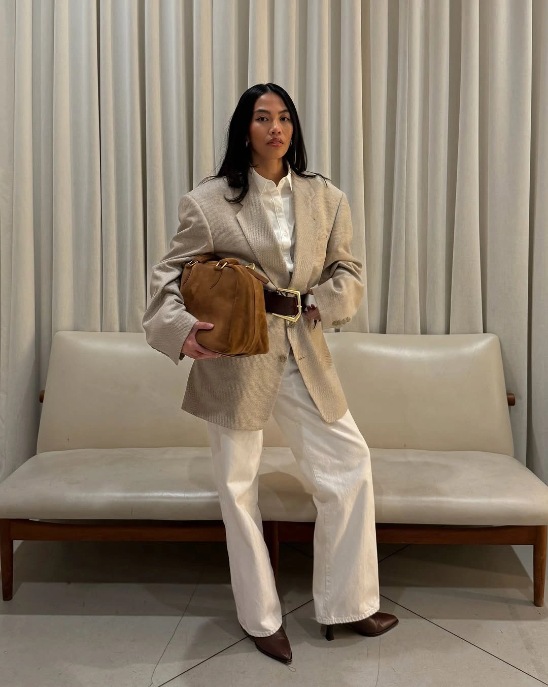 Beige belted blazer with white trousers and brown accessories