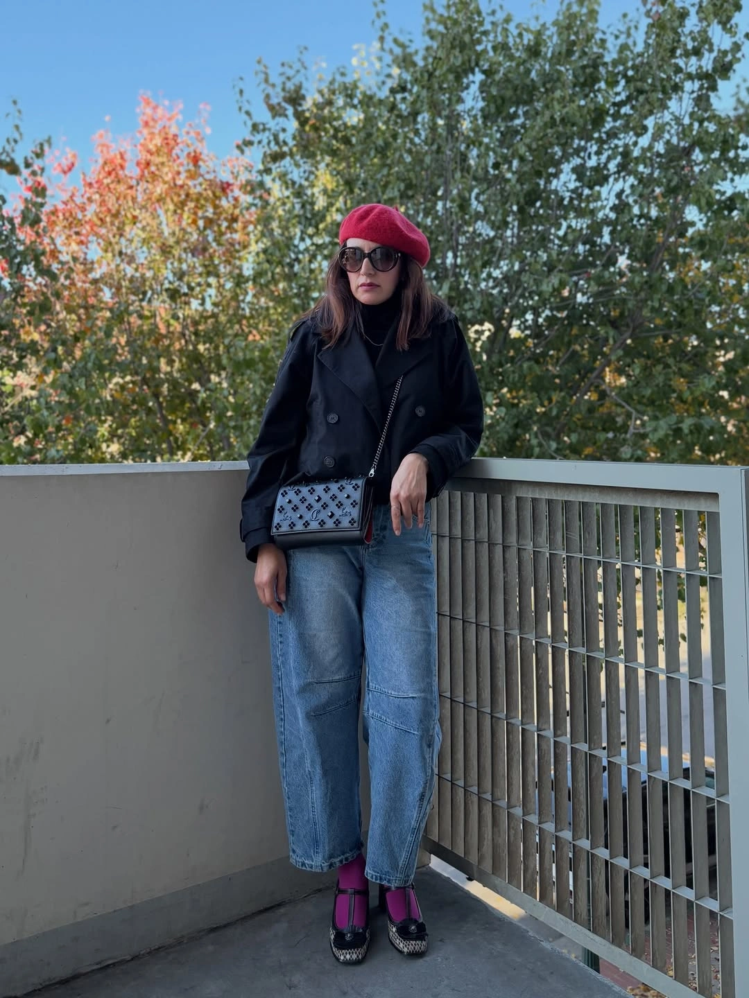 Woman in red beret, cropped jeans, dark jacket, and loafers