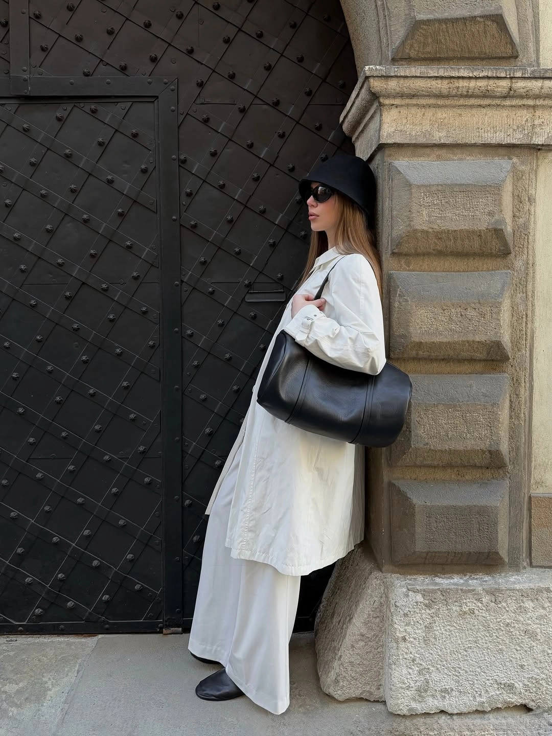 Long white button-front shirt with floor-length white layer and black accessories