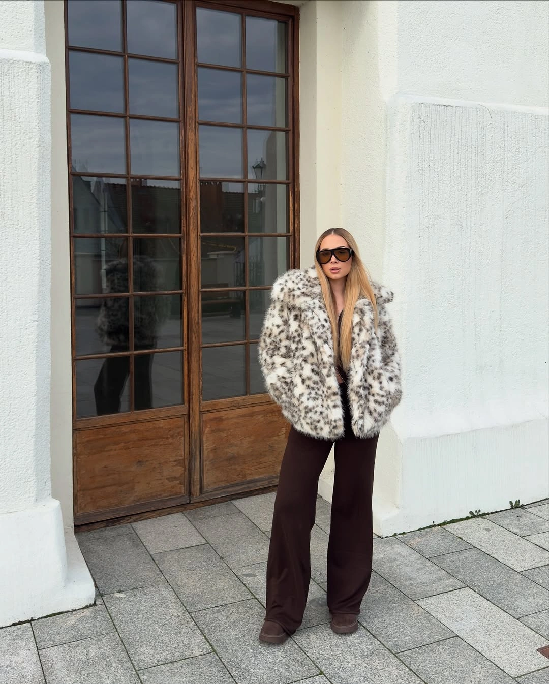 Cream animal-print plush jacket with chocolate wide-leg trousers and sunglasses