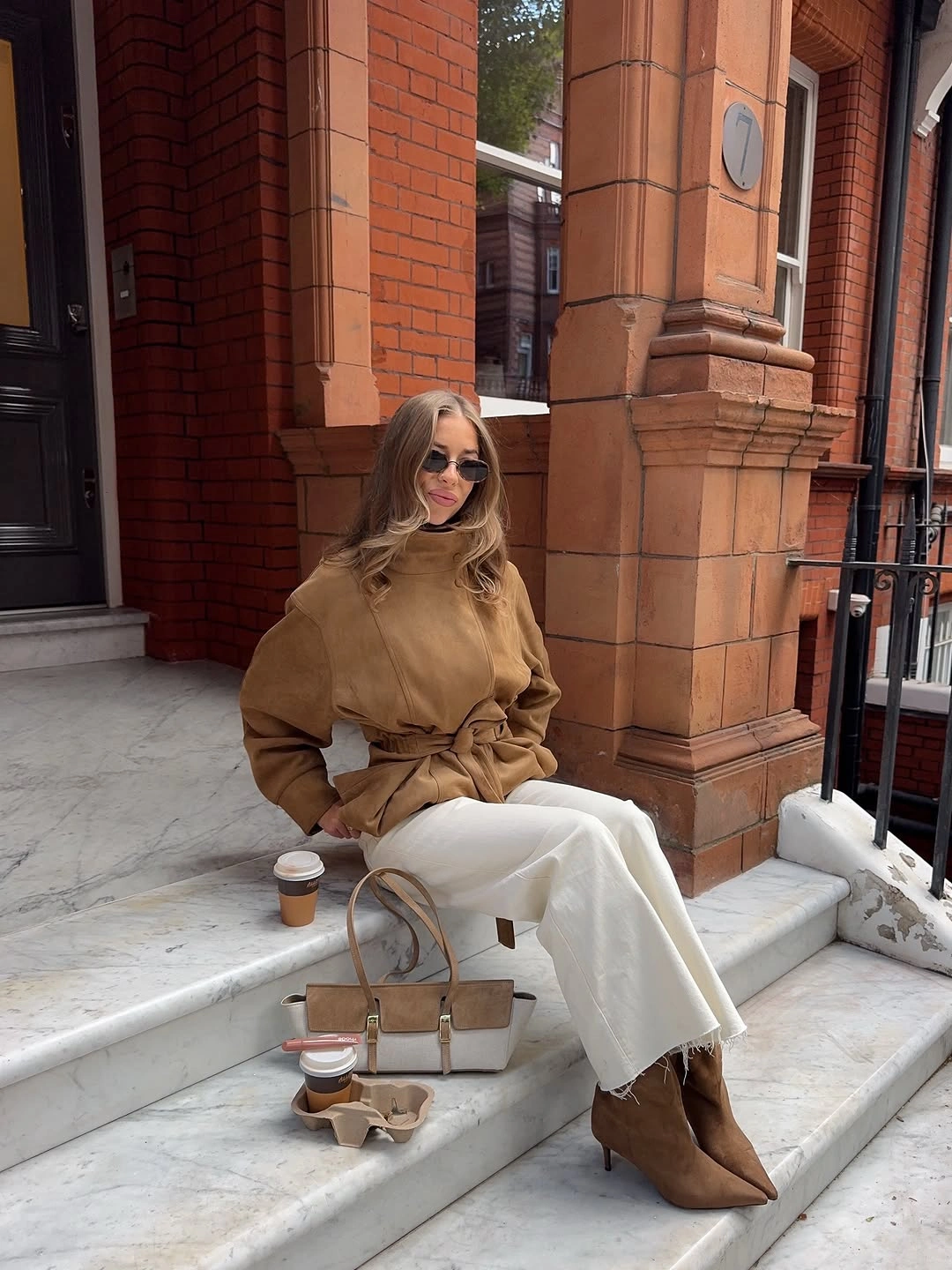 Caramel belted jacket with off-white trousers and brown pointed boots