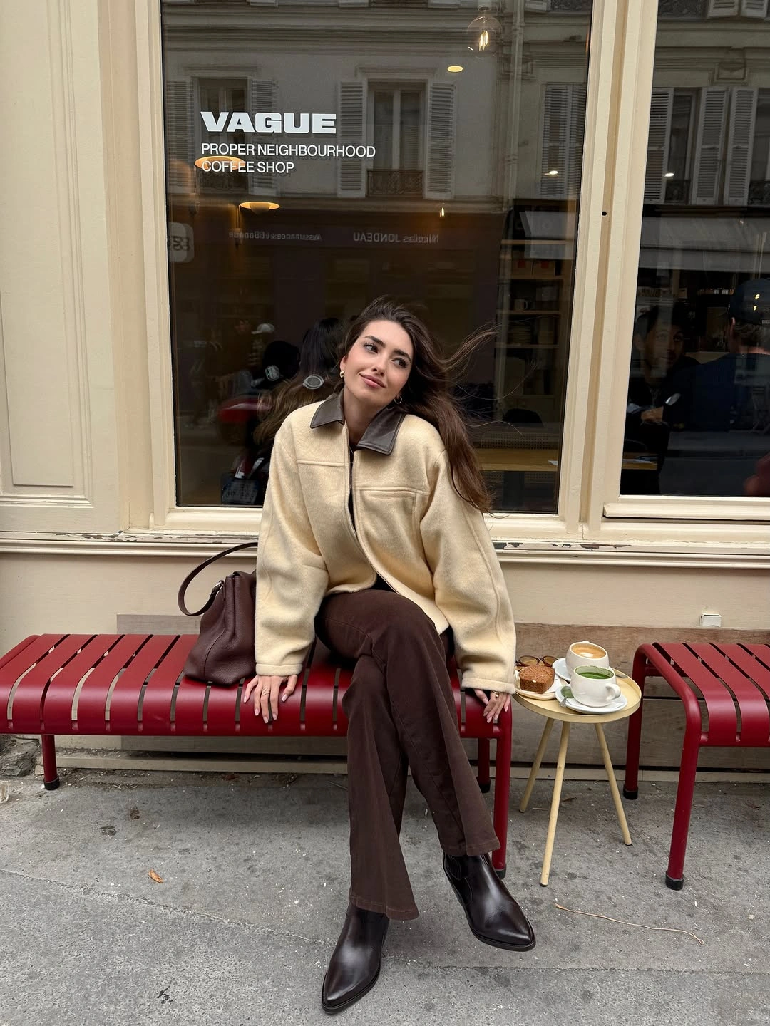 Cream jacket with dark collar brown trousers and pointed ankle boots