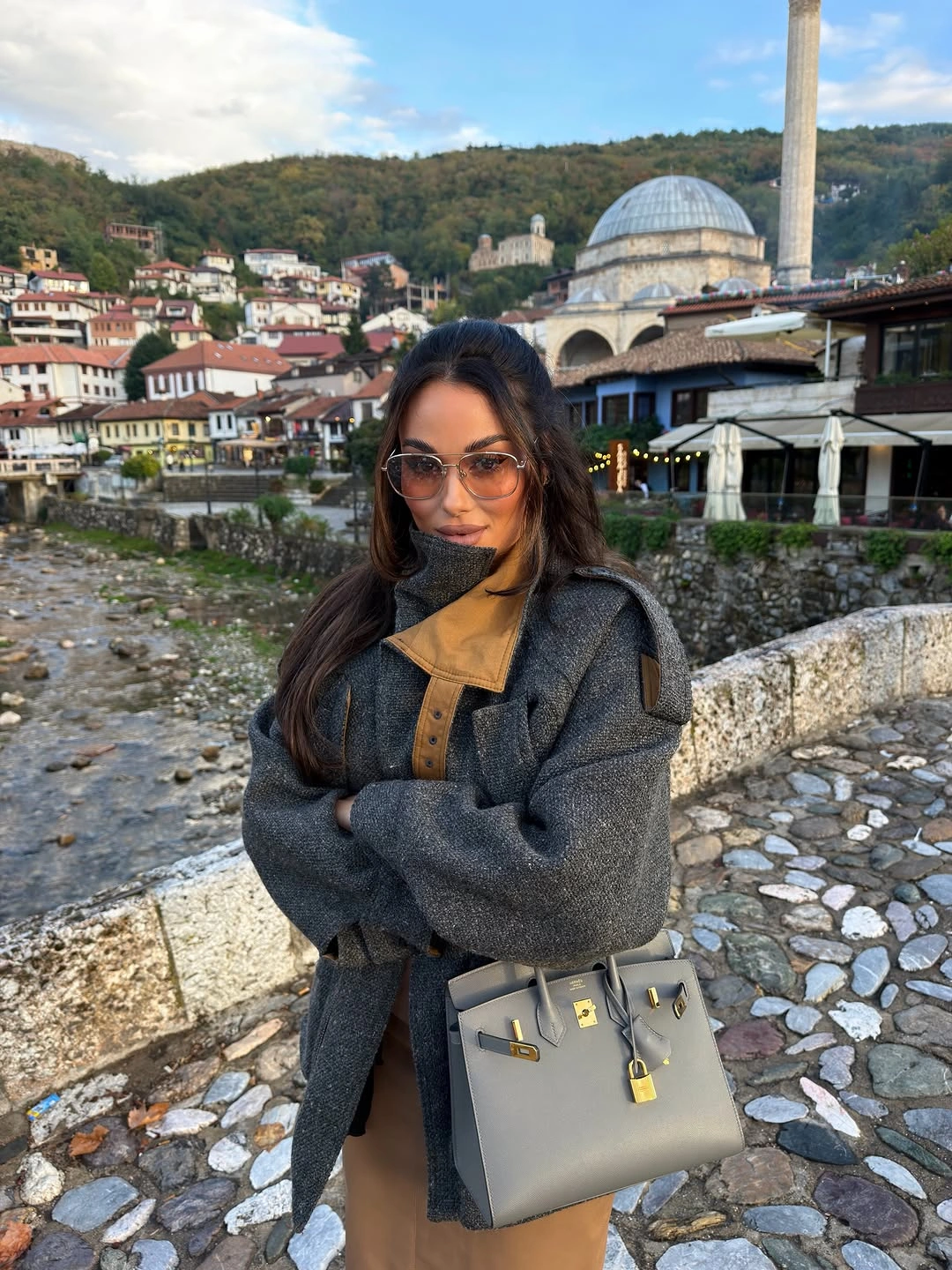 Charcoal textured coat with camel accents and structured gray handbag