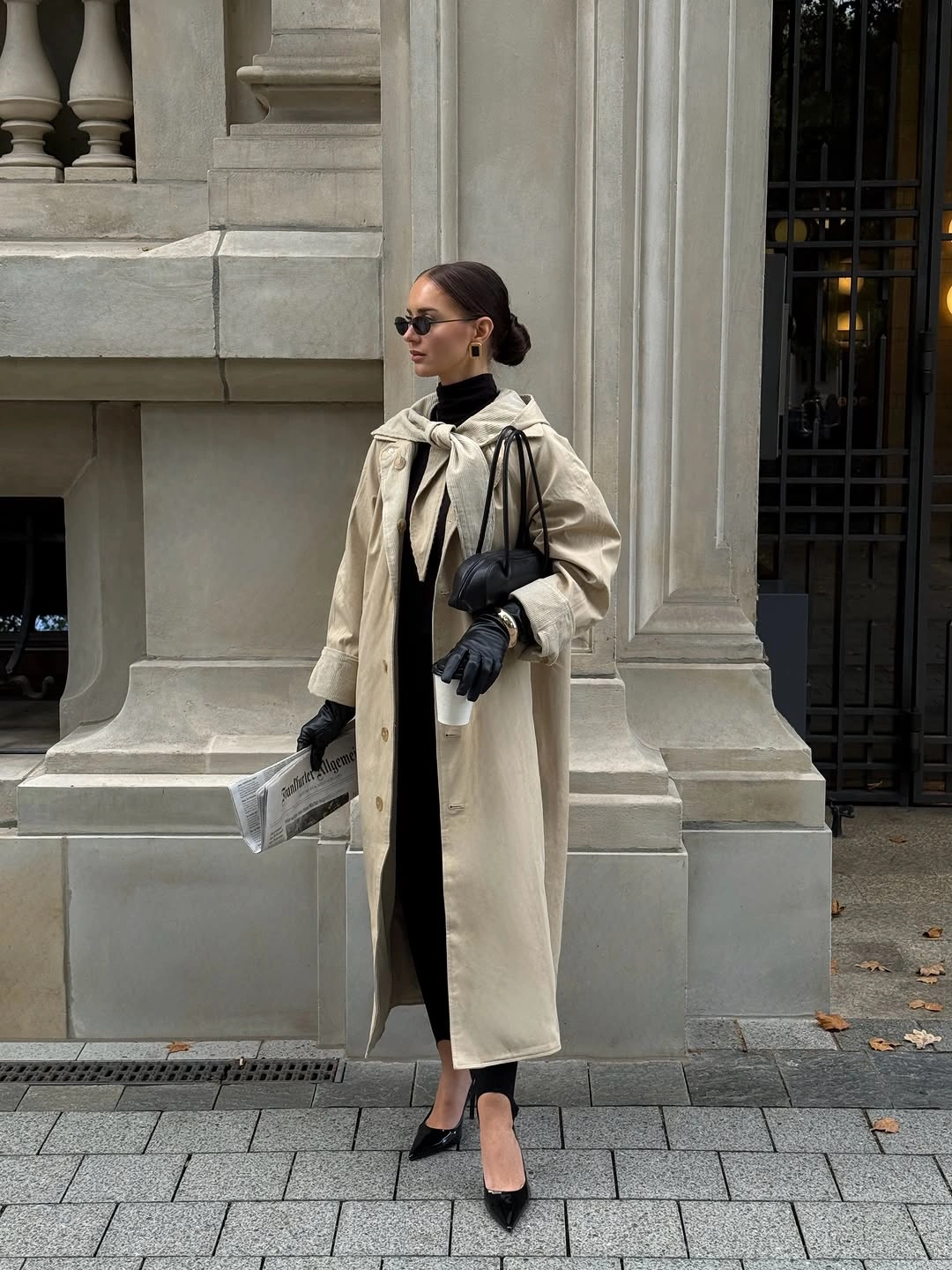 Long ivory coat over black clothing with gloves and pointed heels