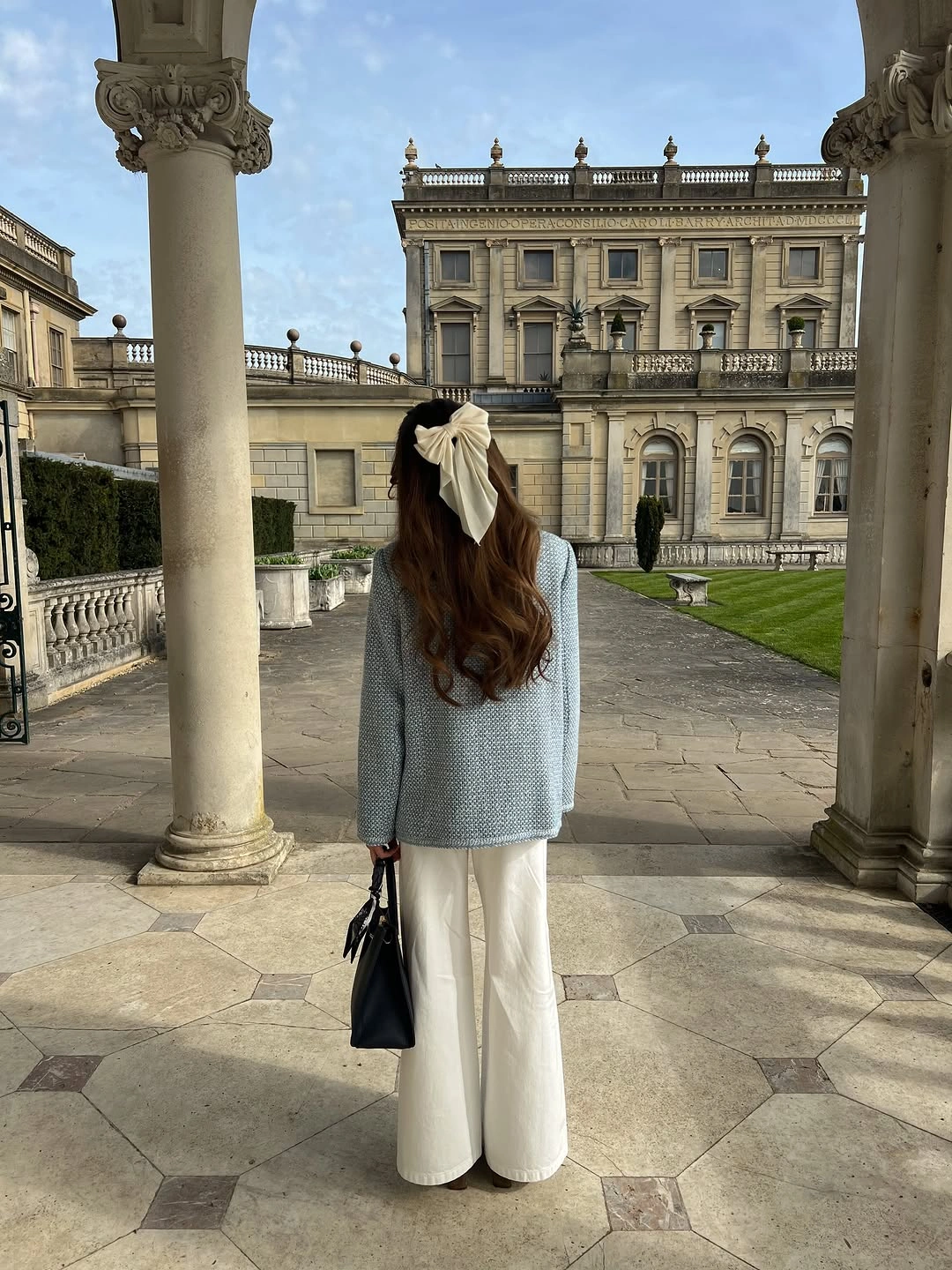 Pale blue textured upper layer cream trousers and ivory hair bow