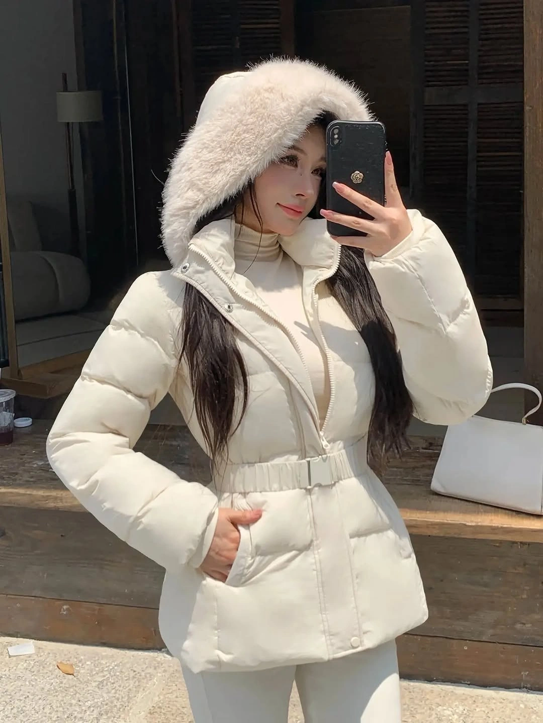 Cream white quilted puffer jacket with matching belt and fluffy head framing