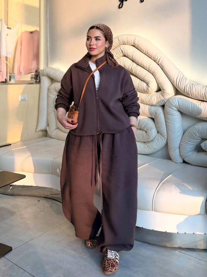 Oversized dark brown top, wide brown pants, and tan crossbody strap
