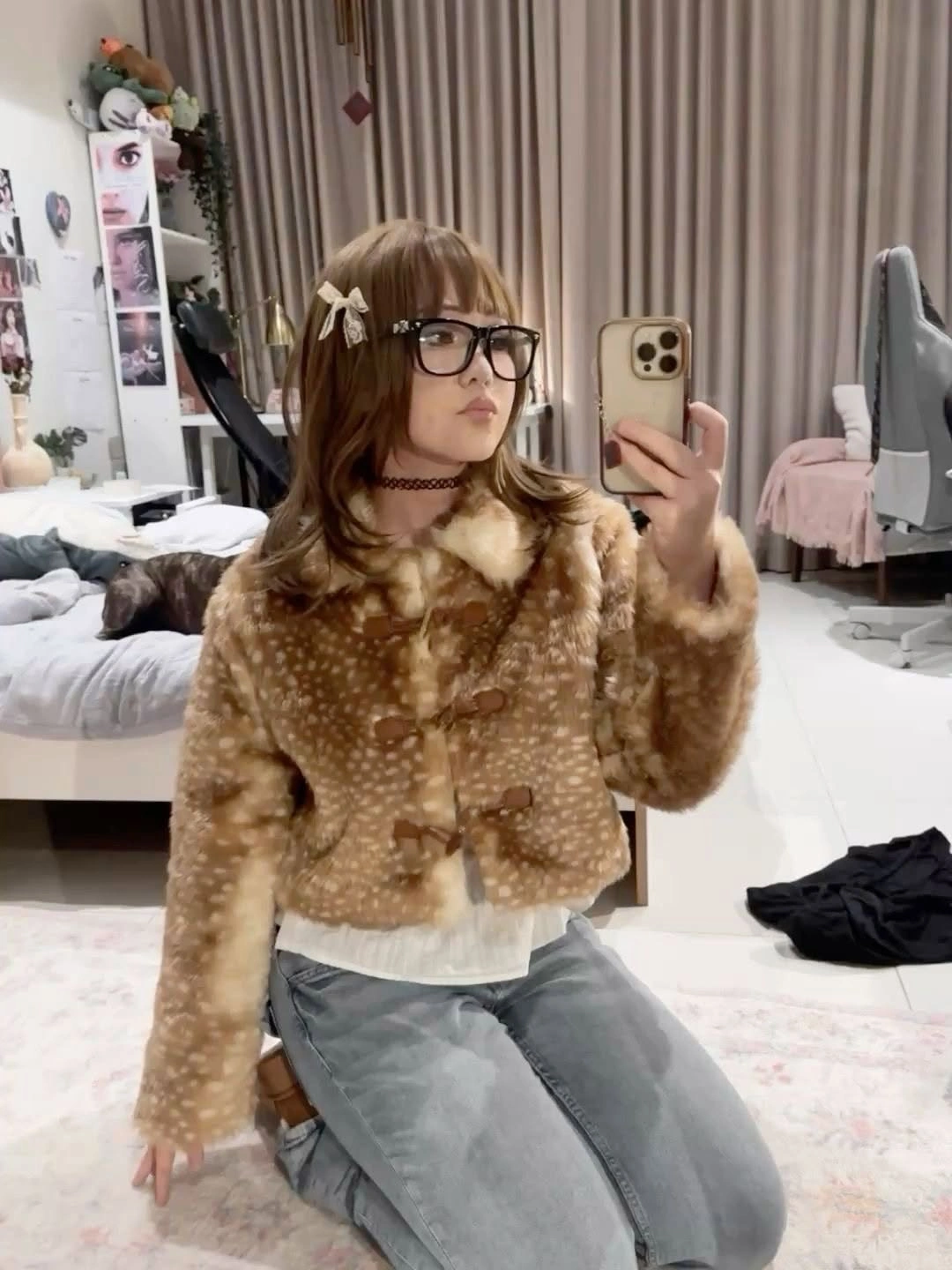 Textured brown cardigan with pale collar, loose gray jeans, and glasses
