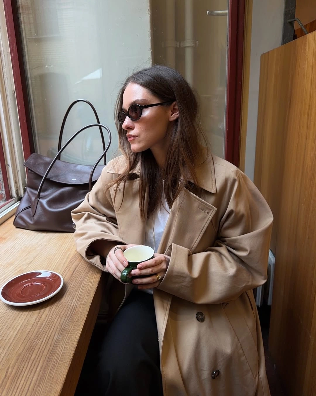 Oversized beige double-breasted coat white top dark pants and brown shoulder bag