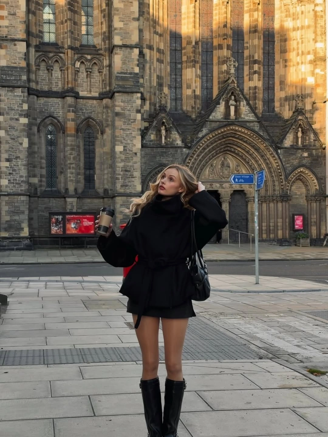 Black high-neck outfit short hem dark tights and knee-high boots