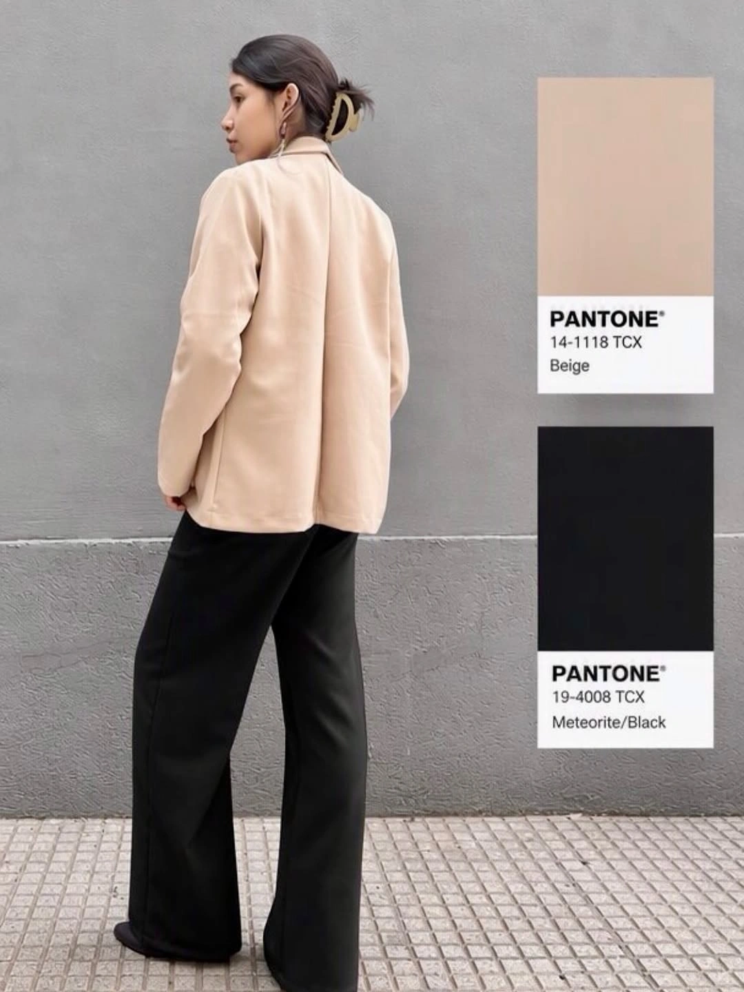 Pale beige tailored jacket black wide-leg trousers and light hair clip