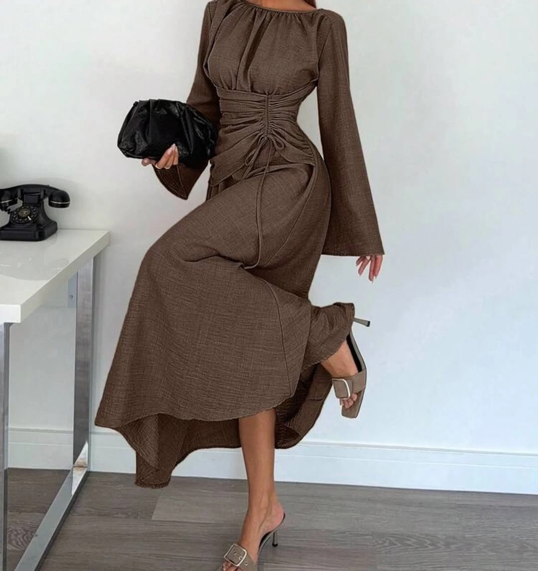 Long brown ruched dress with flared sleeves black clutch and heels