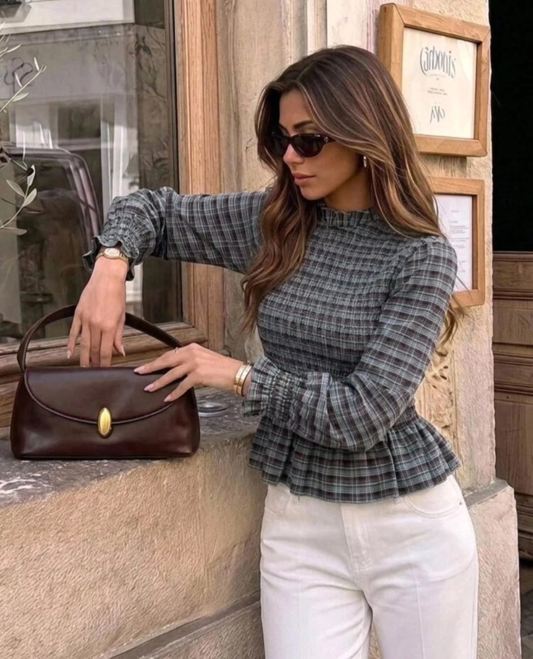 Gray plaid peplum blouse with ivory trousers and brown handbag